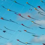 Triangular kites fill the sky